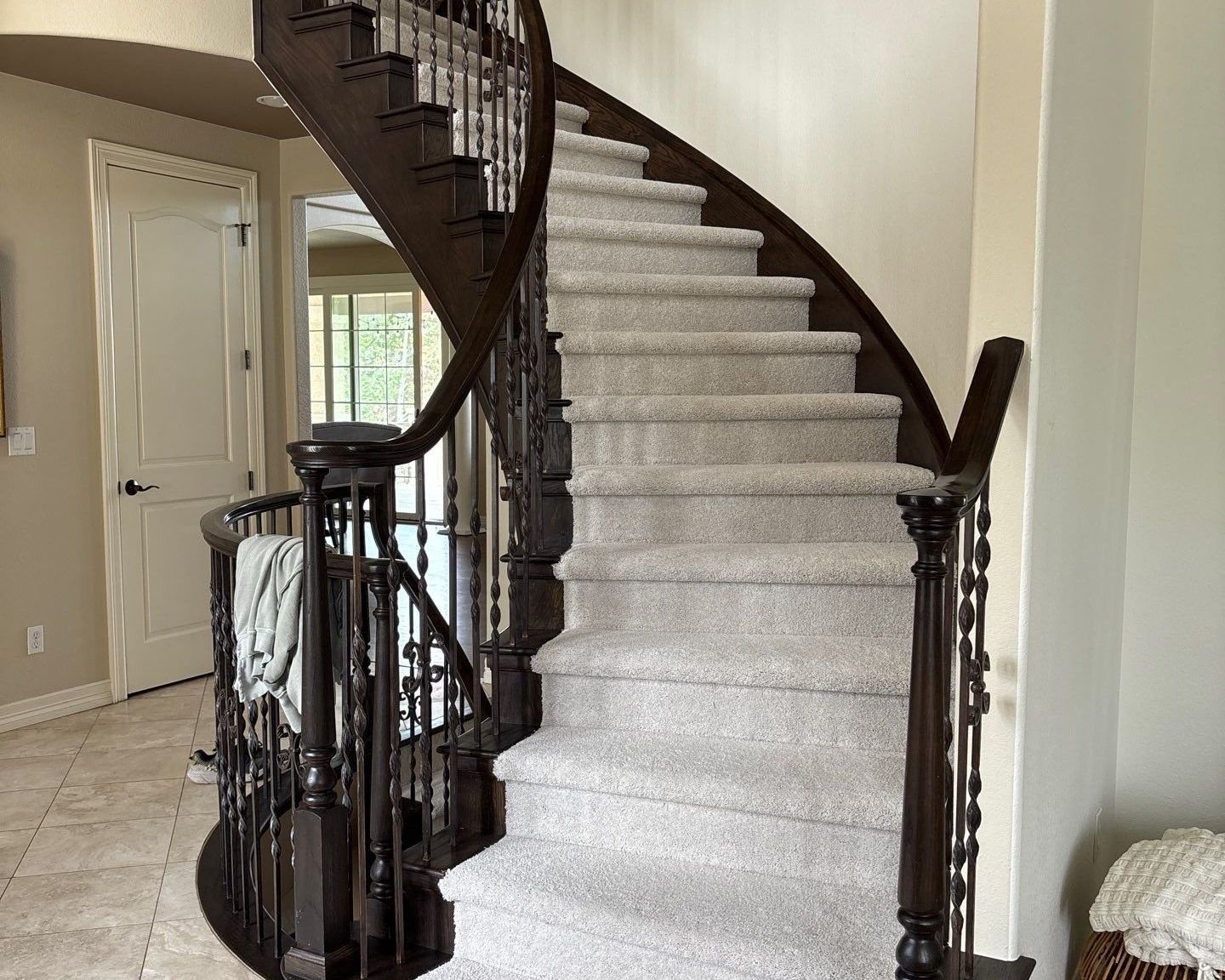 Curved staircase in Lone Tree with new light gray carpet